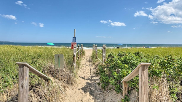 A sandy beach path leading to the ocean with wooden railings and a sign. - Sun-soaked Coastal Cottage w/ Deck + Walk to Beach (Old Orchard Beach)