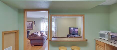 A compact living space with a kitchenette, a dining area, and a living room.
