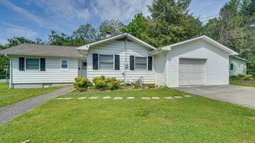 Stunning single-story home with a charming front entrance, garage, and beautifully manicured lawn.