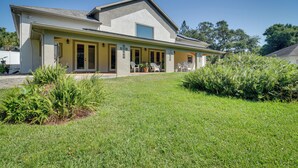 A modern two-story house with a covered porch, a large window, and a well-maintained lawn. - St Petersburg Getaway - 5 Mi to Tropicana Field! (St. Petersburg)