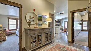 A spacious living area with a wooden cabinet, a large mirror, and a rug. - Mountain-view Condo ~ 9 Mi to Park City Skiing (Heber City)