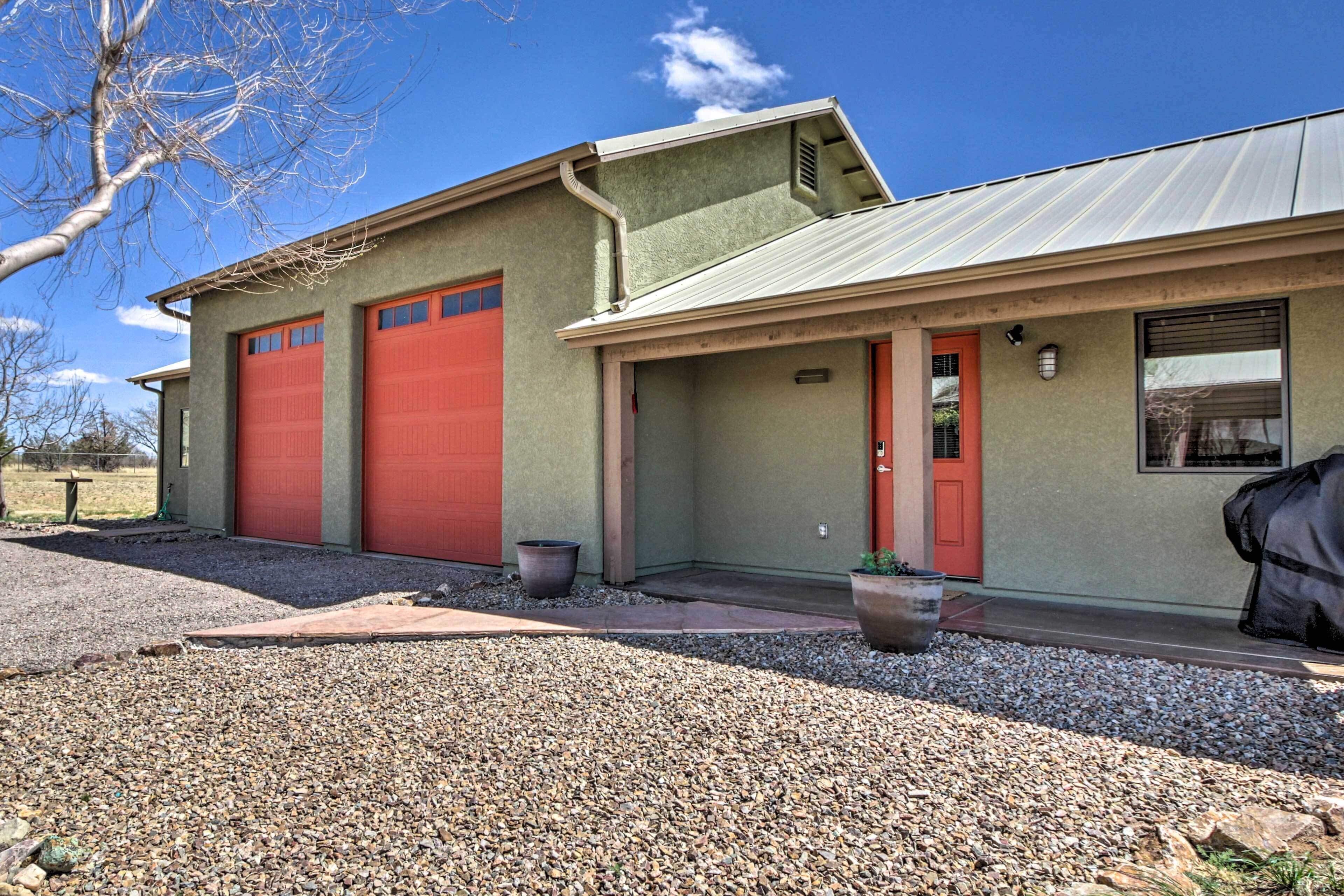 A building with two red garage doors, a red door, and a window.
