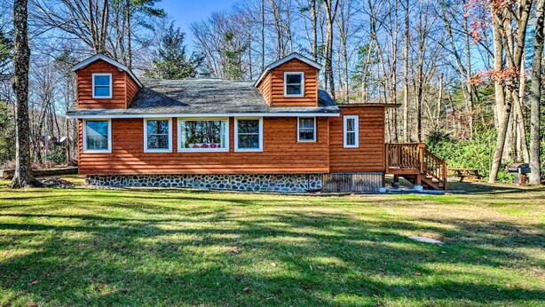 A wooden cabin with a stone foundation, large windows, and a deck. - Cozy Tannersville Gem - Ski, Hike, Explore! (Tannersville)