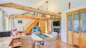 A cozy room with a wooden ceiling, a dining table with wicker chairs, a sofa, and a fireplace. - Cozy Tannersville Gem - Ski, Hike, Explore! (Tannersville)