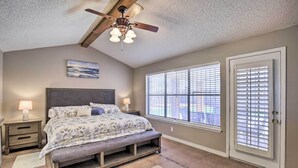 A bedroom with a bed, nightstands, a ceiling fan, and a window with blinds. - Large Yard: Family-friendly El Paso Rental Home (El Paso)