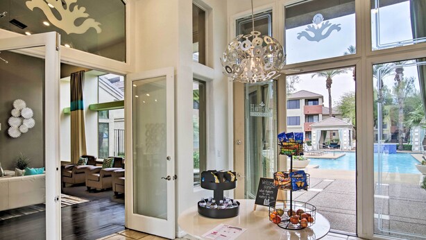 A hotel lobby with a pool view, a reception desk, and a seating area. - Modern Condo w/ Pool Access ~ 3 Mi to Dtwn Phoenix (Phoenix)