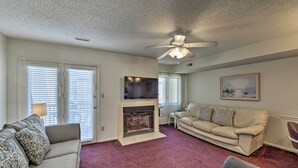 A living room with a fireplace, two sofas, a ceiling fan, and a television. - Townhome w/ Balcony < 1 Mi to Wildwood Crest Bch! (Wildwood Crest)