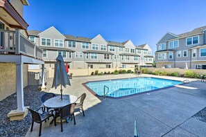 A residential building with a swimming pool, patio furniture, and a clear blue sky. - Townhome w/ Balcony < 1 Mi to Wildwood Crest Bch! (Wildwood Crest)