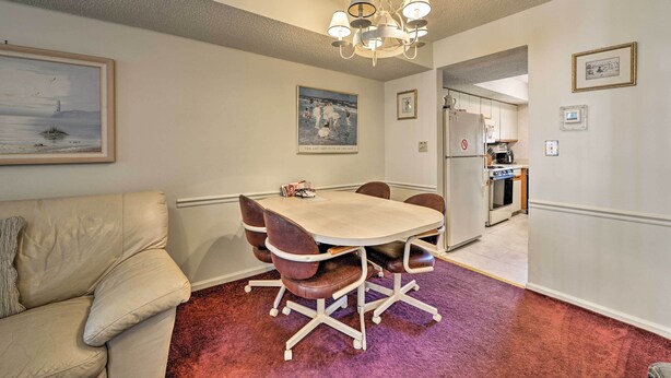 A dining area with a table and chairs, a sofa, and a kitchen in the background. - Townhome w/ Balcony < 1 Mi to Wildwood Crest Bch! (Wildwood Crest)