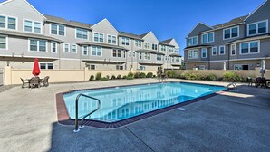 A swimming pool with a metal ladder, surrounded by a concrete deck, and a patio area with outdoor furniture. - Townhome w/ Balcony < 1 Mi to Wildwood Crest Bch! (Wildwood Crest)
