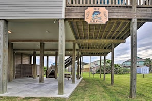A covered outdoor area with wooden pillars, a picnic table, and a sign reading "Blue Scalawag." - Deck & Ocean Views: Home in Crystal Beach! (Port Bolivar)