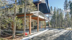 A two-story building with a covered porch and a solar panel on the roof. - Outdoor Adventure Hub ~ 20 Miles to Yellowstone! (Island Park)