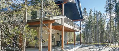 A two-story building with a covered porch and a solar panel on the roof.