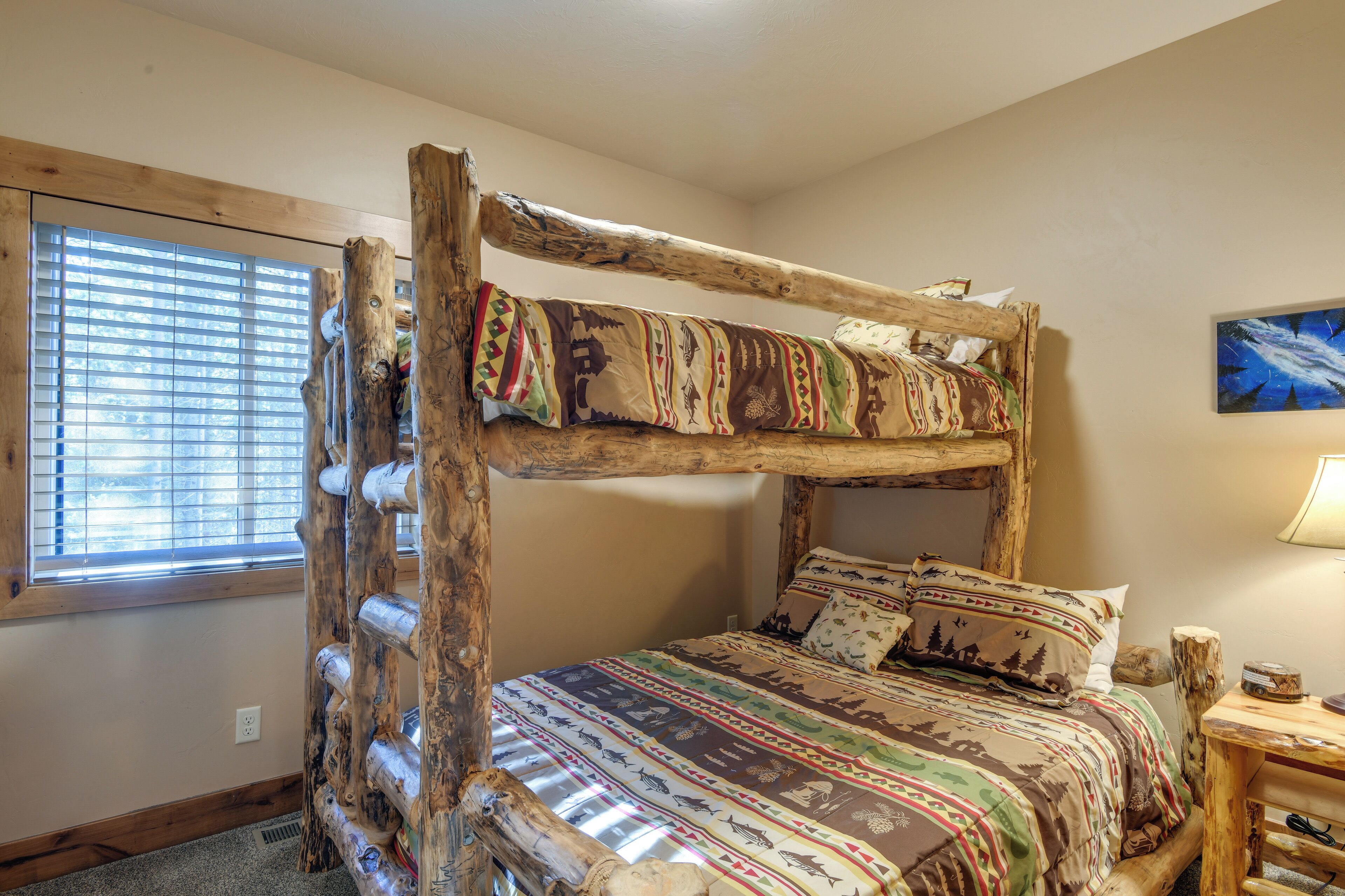 A bunk bed with a wooden frame and patterned bedding.