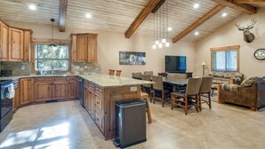 A spacious kitchen with wooden cabinets, a granite countertop, and a built-in island. - Outdoor Adventure Hub ~ 20 Miles to Yellowstone! (Island Park)