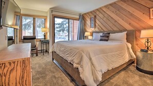 A bedroom with a large bed, a desk, and a chair. - The Mammoth Lodge by Hiking, Lakes, Skiing & More! (Mammoth Lakes)