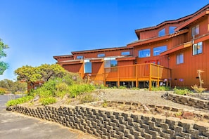 A multi-story building with a wooden facade, a balcony, and a landscaped garden area. - Spacious Royal Oaks Retreat w/ Deck & Views! (Watsonville)
