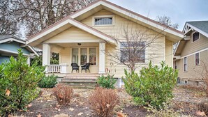A two-story house with a front porch, two chairs, and a small garden with shrubs and fallen leaves. - Peaceful Wine Country Getaway - Walk to Downtown! (Walla Walla)