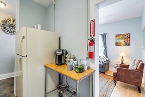 A compact kitchen with a refrigerator, coffee machine, and a small table with a kettle and cups. - 'St Ceilia' Apt - Walk to Bisbee Attractions! (Bisbee)