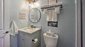 A bathroom with a sink, mirror, toilet, and towel rack. There are signs on the wall, including one that says "WASH YOUR HANDS" and another that says "FRESH SOAP & WATER 5¢". - 1 Mi to Skiing: Beech Mountain Condo w/ Fireplace! (Banner Elk)