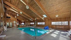 An indoor swimming pool with wooden walls and ceiling, surrounded by lounge chairs and a sunroof. - 1 Mi to Skiing: Beech Mountain Condo w/ Fireplace! (Banner Elk)