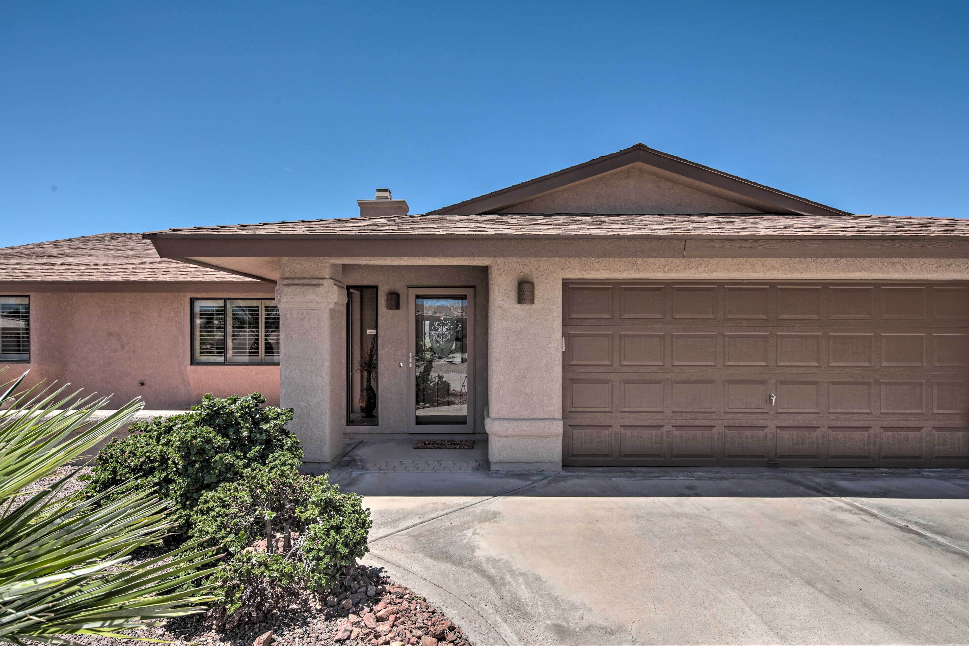 A single-story house with a garage, a front door, and a small porch area.