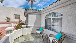 A patio with wicker furniture and a large window. - Pool, Patio & Lake Views: Lake Havasu City Home! (Lake Havasu City)