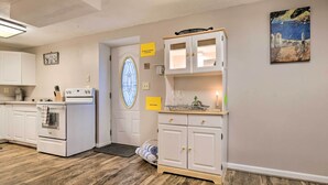 A kitchen with white cabinets, a stove, and a window with a stained glass design. - Bel Air Apartment w/ Pool ~ 2 Mi to Main St (Bel Air)