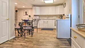 A compact kitchen with white cabinets, a microwave, and a refrigerator. - Bel Air Apartment w/ Pool ~ 2 Mi to Main St (Bel Air)
