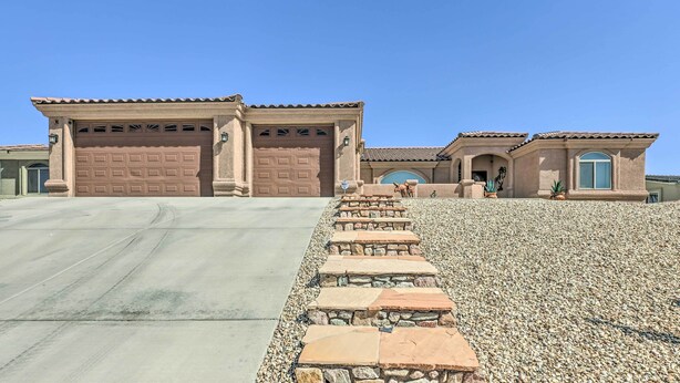 A two-story house with a stone staircase leading to the front door. - 3br/3ba, 360° Views, Min to London Bridge/trails (Lake Havasu City)