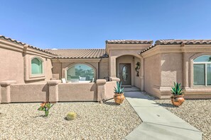 A building with a tiled roof, arched windows, and a pathway leading to a door. There are potted plants and a cactus in the foreground. - 3bd/3bath/360°views/min to London Bridge/trails (Lake Havasu City)