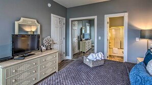 A bedroom with a television, dresser, and a walk-in closet. - Myrtlewood Golf Resort Condo With Pool Access (Myrtle Beach)