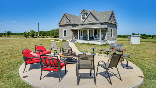 A house with a covered patio area featuring outdoor furniture and a grill. - Decatur Farmhouse Getaway w/ Deck & Backyard (Decatur)
