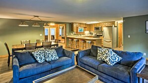 A modern kitchen with wooden cabinets, a stainless steel refrigerator, and a bar area. - Boat Dock, Game Room: Lakefront Sunrise Beach Home (Sunrise Beach)