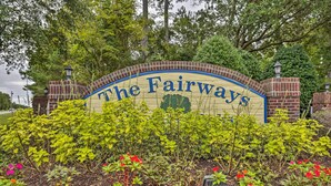 A sign for The Fairways with a brick arch and a landscaped garden in front. - First-floor Myrtle Beach Condo w/ Pool Access! (Myrtle Beach)