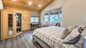 A bedroom with a wooden ceiling, a bed with a plaid bedspread, a desk with a chair, and a wardrobe. - 6 Mi to Homewood Mountain Resort: Tahoe City Gem! (Tahoe City)