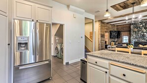 A modern kitchen with stainless steel appliances, a granite countertop, and a stone accent wall. - 6 Mi to Homewood Mountain Resort: Tahoe City Gem! (Tahoe City)