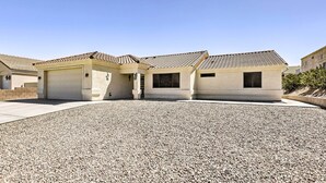 A residential building with a gravel driveway and a tiled roof. - Fort Mohave Home < 8 Mi to Colorado River! (Fort Mohave)