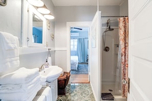A bathroom with a sink, mirror, and shower. - 'St Blaise' Bisbee Apt < 1 Mi to Attractions! (Bisbee)