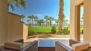 A patio with wicker furniture and a view of the ocean. - Paraiso del Mar Resort Condo: Water Taxi to La Paz (La Paz)