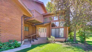 A two-story brick house with a front porch, a small garden, and a tree. - Superb Park City Escape w/ Deck, Walk to Ski Lift! (Park City)