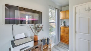 A modern kitchen with a built-in oven, a large window with curtains, wooden cabinets, and a printer on a wooden table. - 2 Mi to Dtwn Atascadero! Cozy Cottage w/ Yard (Atascadero)
