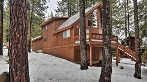 A wooden cabin with a staircase leading to a deck, surrounded by tall trees and snow. - Truckee Winter Escape 6 Mi to Ski Slopes! (Truckee)