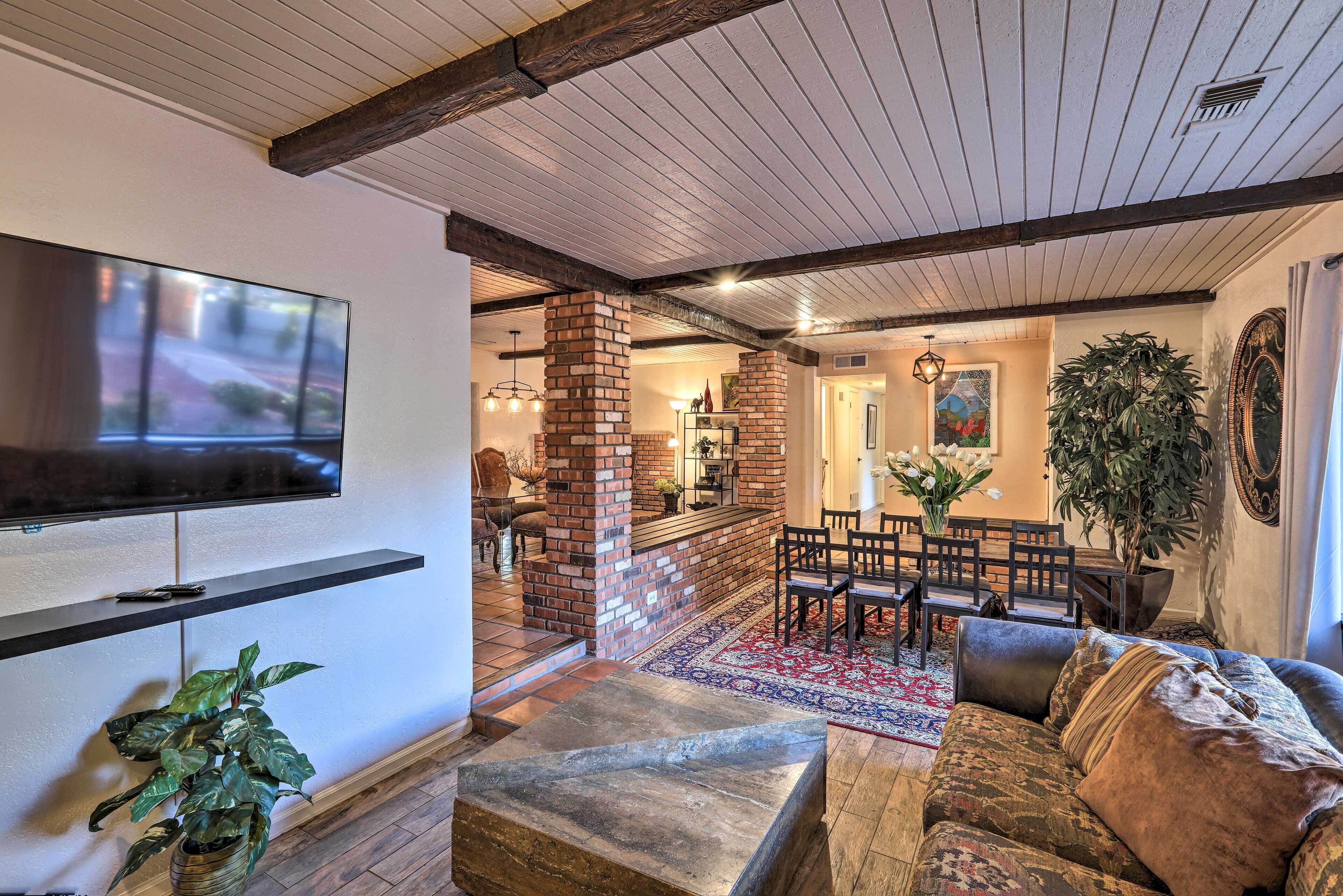 Una sala de estar con televisión, asientos, chimenea y comedor.