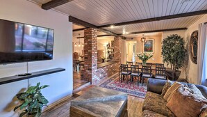 A living room with a TV, seating, a fireplace, and a dining area. - Hot Tub & Fire Pit: Sedona Oasis! (Sedona)