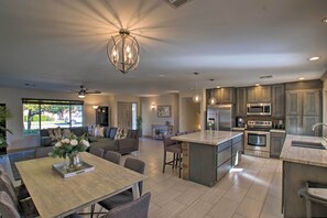 A spacious kitchen with a large island, modern appliances, and a dining area with a table and chairs. - 3 Mi to Old Town Scottsdale: Upscale Home w/ Pool! (Scottsdale)