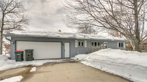 A single-story house with a garage, a driveway, and snow accumulation around the property. - Breezy Point House w/ Dock on Pelican Lake! (Pequot Lakes)