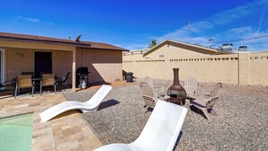 A patio area with outdoor seating, a barbecue grill, and a water feature. - 5 Mi to Lake Havasu: Home w/ Yard & Pool (Lake Havasu City)
