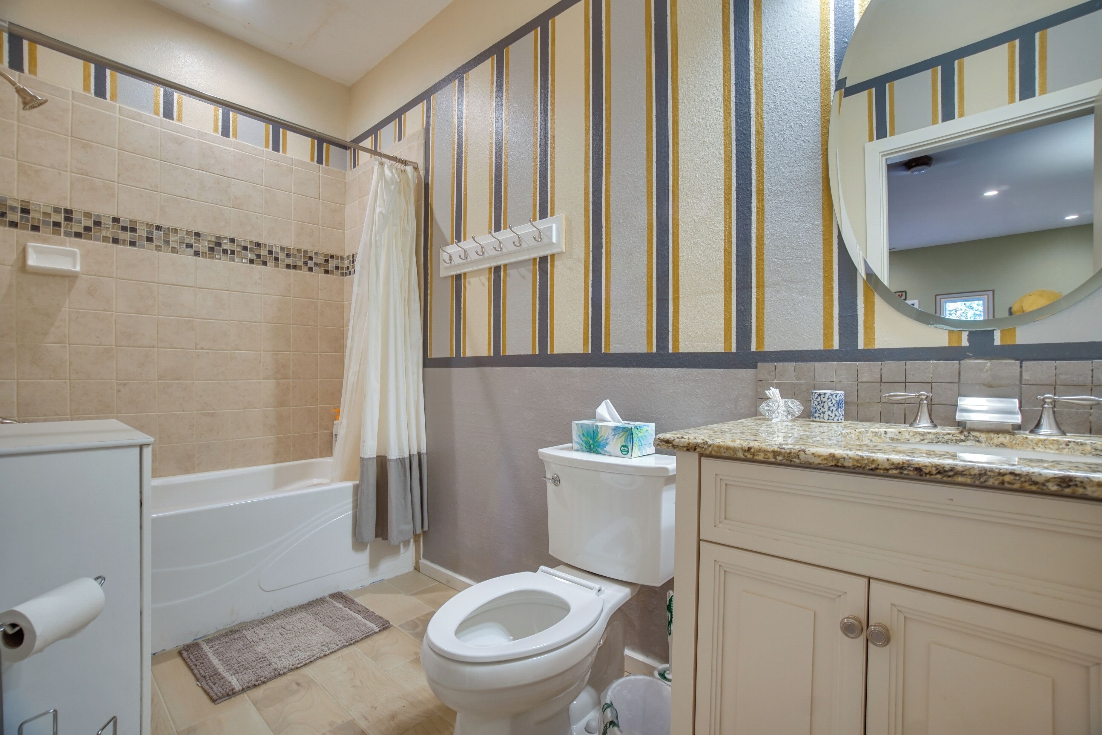 A bathroom with a bathtub, toilet, and sink.