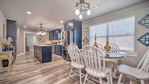 A modern kitchen with dark blue cabinets, stainless steel appliances, and a central island. - Lakefront Fort Towson Home: Private Dock & 3 Decks (Fort Towson)